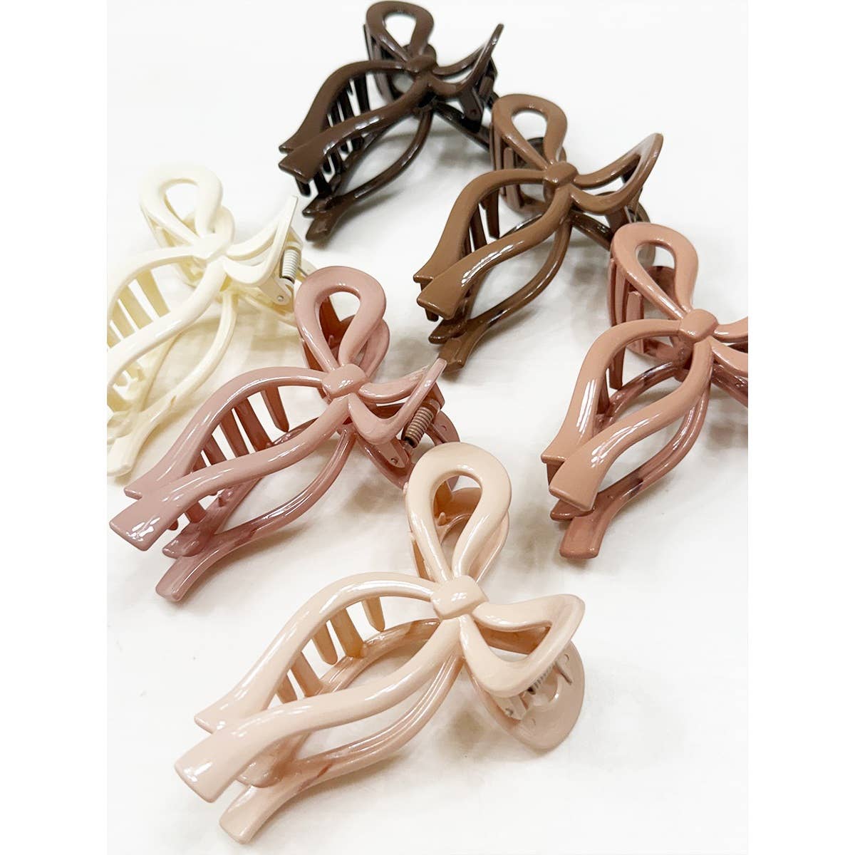 Set of bow-shaped hair clips in various colors on a white background