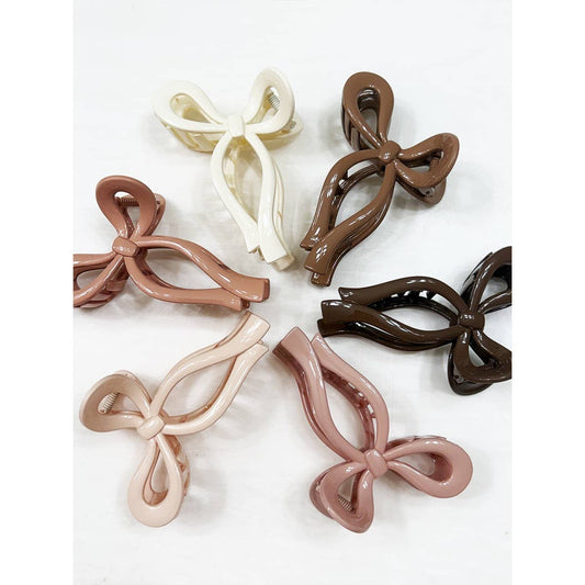 Set of bow-shaped hair clips in various colors on a white background