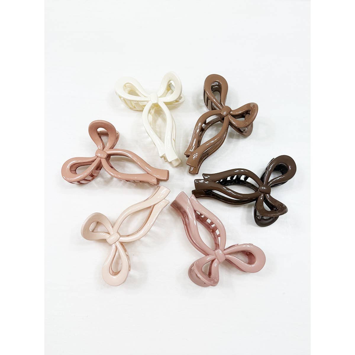 Set of bow-shaped hair clips in various colors on a white background